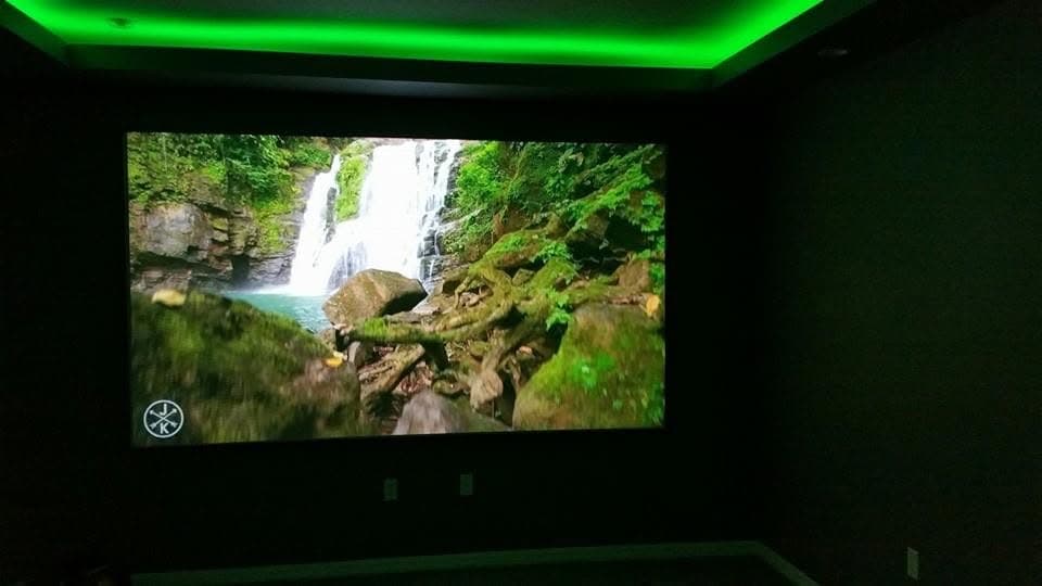 The same theater screen under green cove lighting